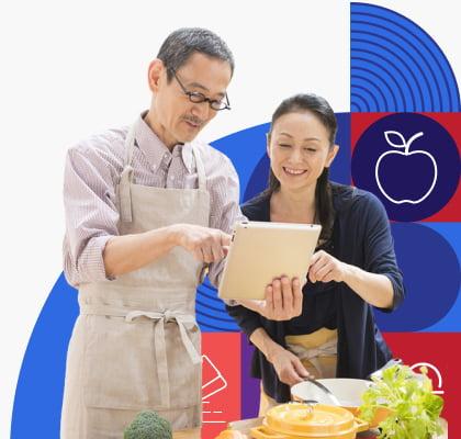 Man and woman looking at a tablet together.