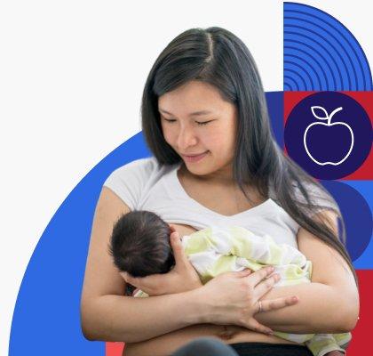 A young woman lovingly looks down at her infant while she breastfeeds.