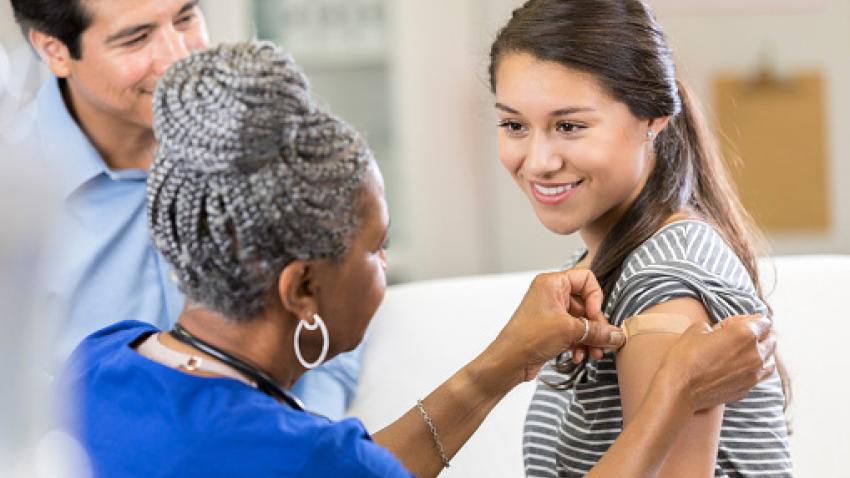 Woman receiving vaccine from a provider.