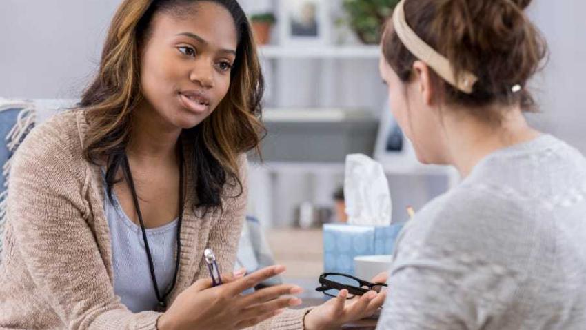  A patient and health care provider sit and talk