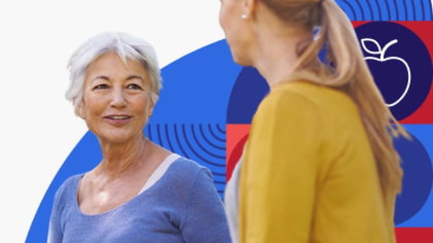 An older woman talks to younger woman.