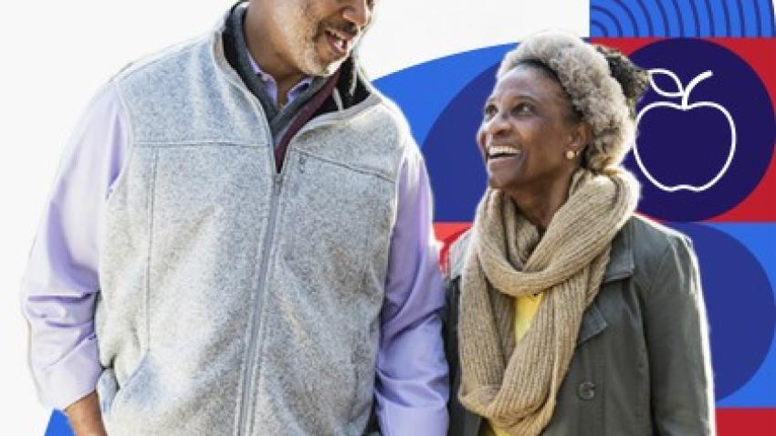 A man and woman hold hands while walking.